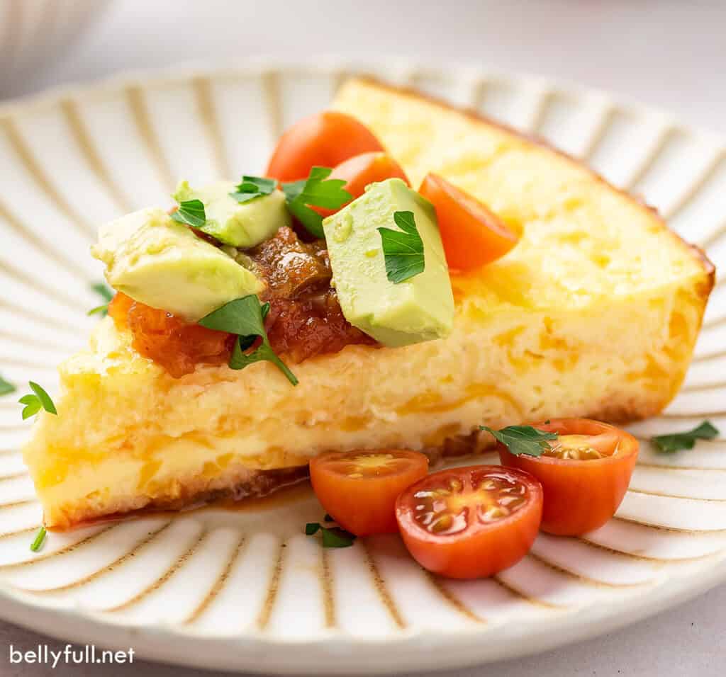 slice of thick egg omelet with cherry tomatoes and avocado