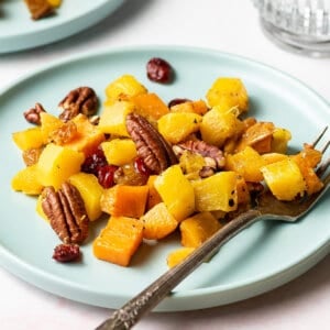 a plate with roasted winter squash and pecans