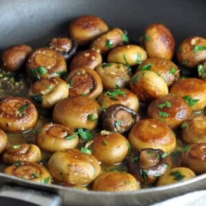 whole sauteed mushrooms in skillet