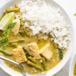 A bowl of Thai green curry with fish and jasmine rice