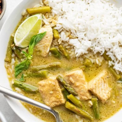 A bowl of Thai green curry with fish and jasmine rice