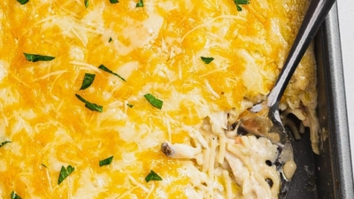 turkey tetrazzini in casserole dish with portion on serving spoon