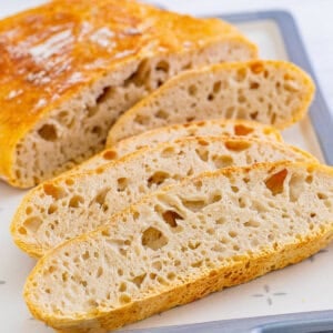 A loaf of no knead bread with 3 slices