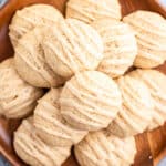 overhead pile of eggnog cookies with icing on wooden plate