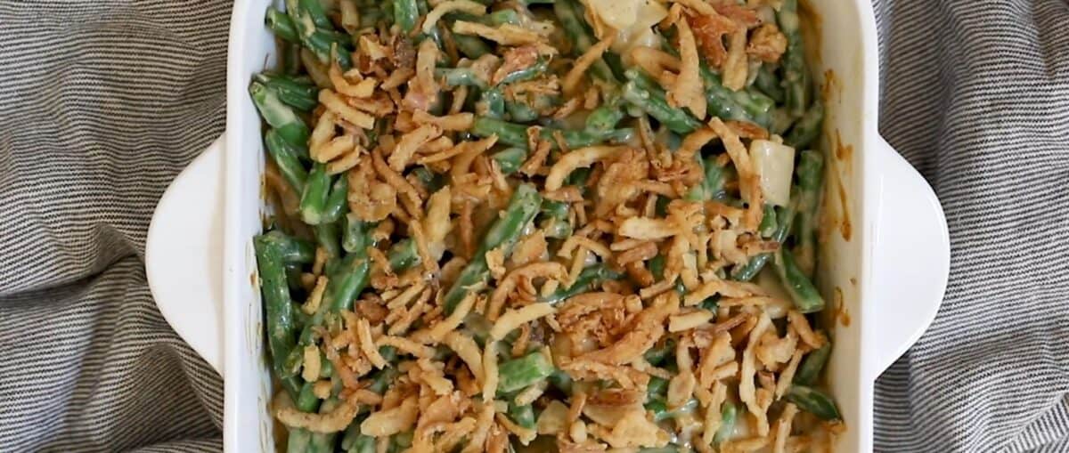 Sprinkling fried onions on top of the casserole. 