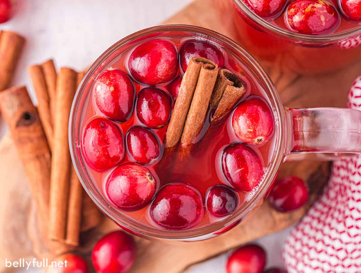 Overhead view of a glass of cranberry apple cider