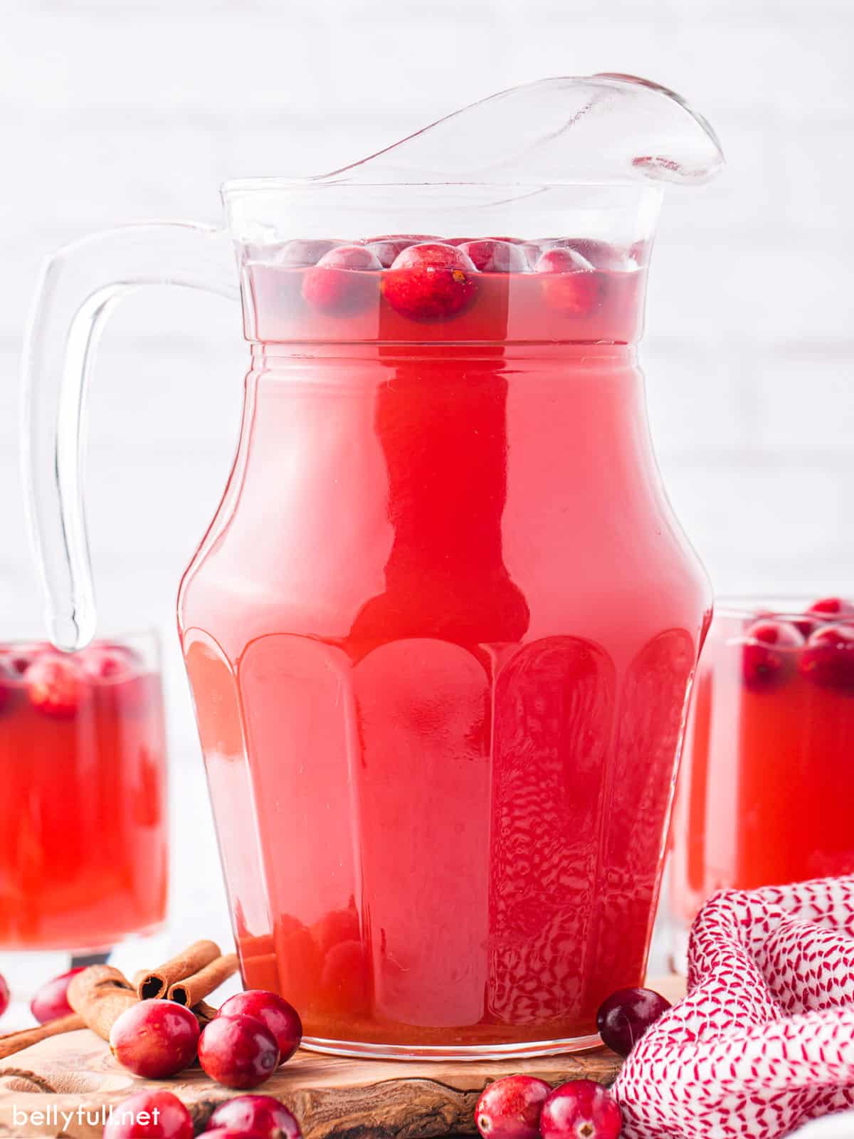 A pitcher of cranberry apple cider