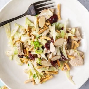 Leftover turkey salad on a white plate with a fork