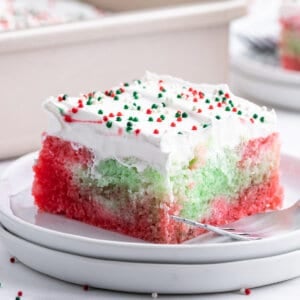 Square slice of Christmas Jello Poke Cake on plate