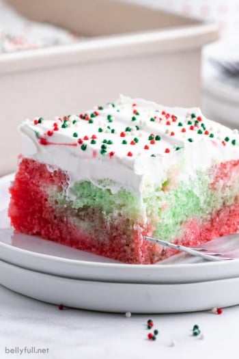 Square slice of Christmas Jello Poke Cake on plate