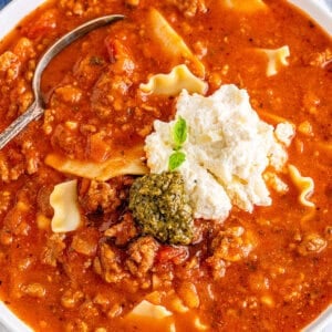Overhead view of a bowl of easy lasagna soup with a dollop of cheese and pesto