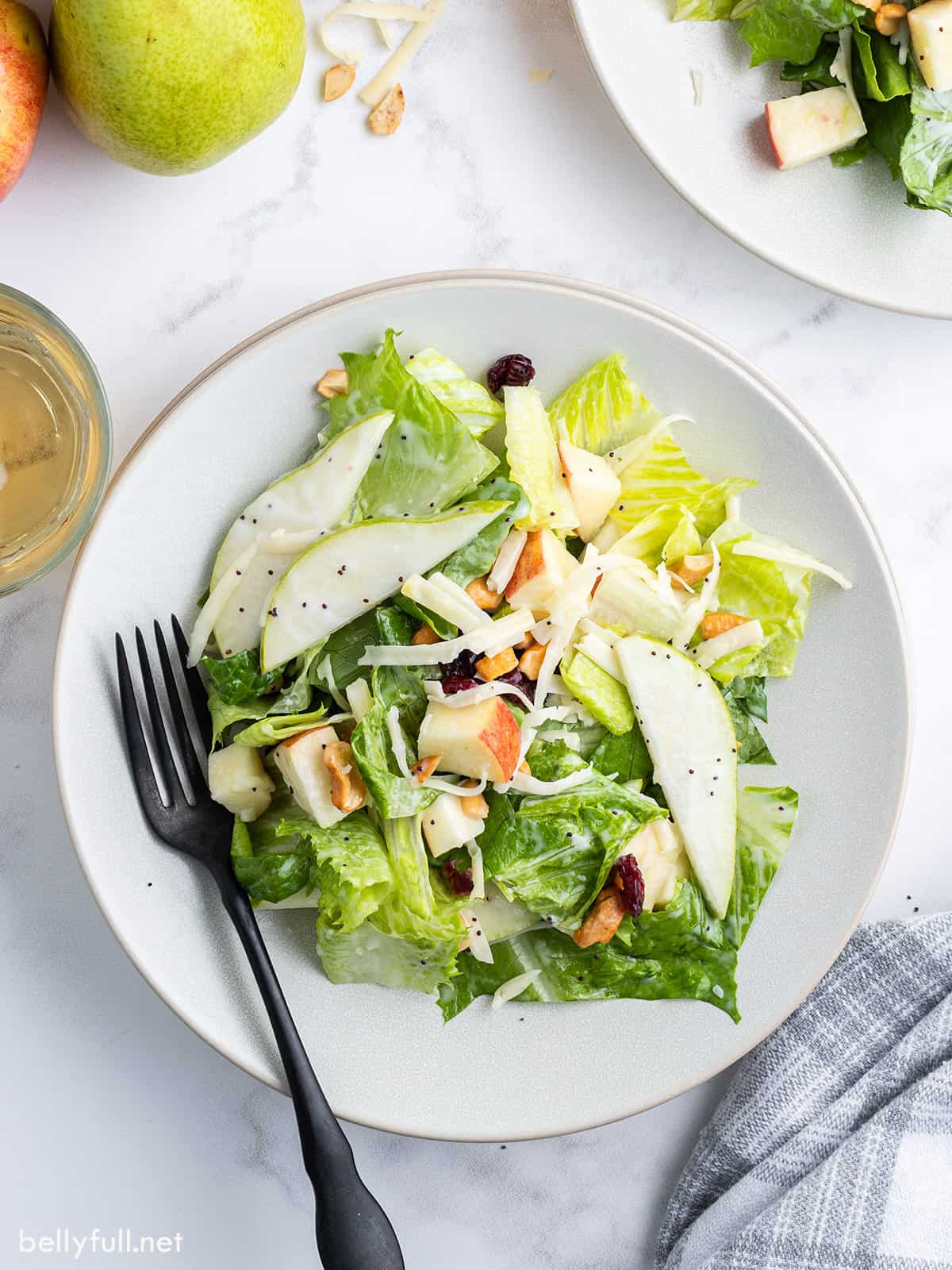 Pear salad on a plate with a spoon