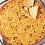 overhead corn dip in glass dish with 2 tortilla chips