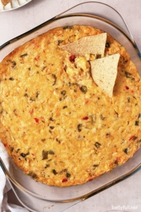 overhead corn dip in glass dish with 2 tortilla chips