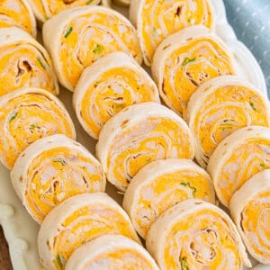 Overhead view of buffalo chicken roll-ups on a white platter