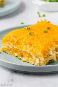 A square slice of pierogi lasagna on a blue plate