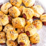 Overhead view of a pile of mini pigs in a blanket