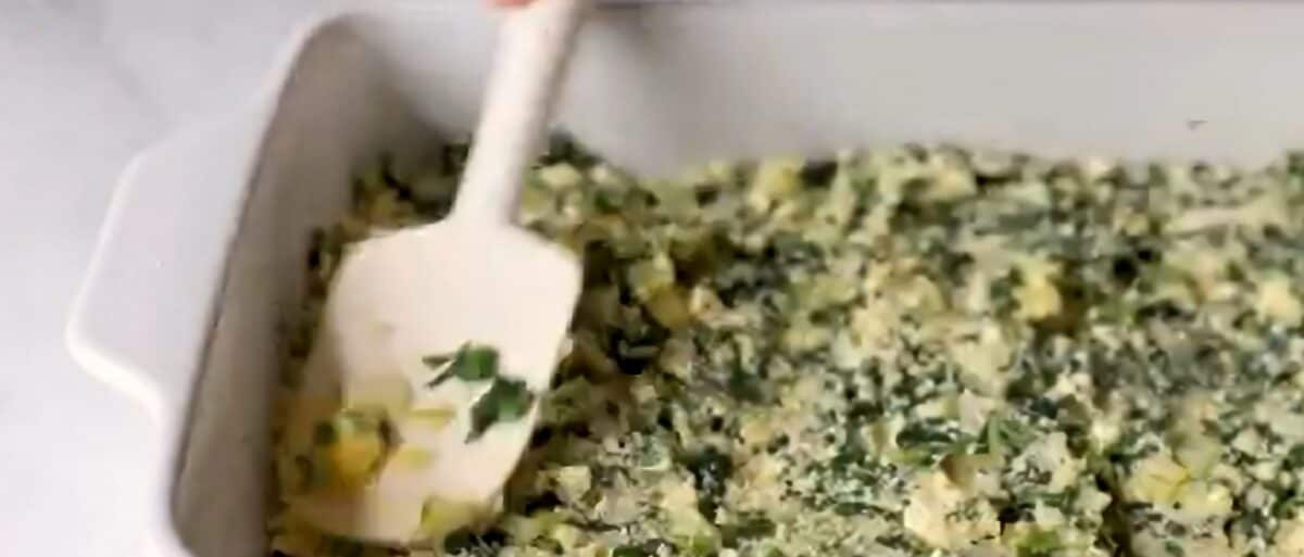 Spreading the spinach filling over the phyllo. 