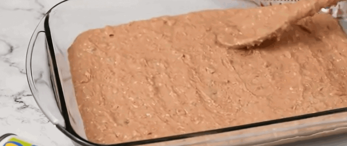 Bean layer spread into a baking dish.