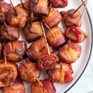 Overhead view of bacon wrapped water chestnuts on a white plate