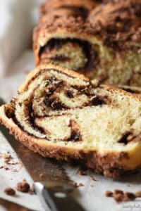 close up slice of chocolate challah with knife