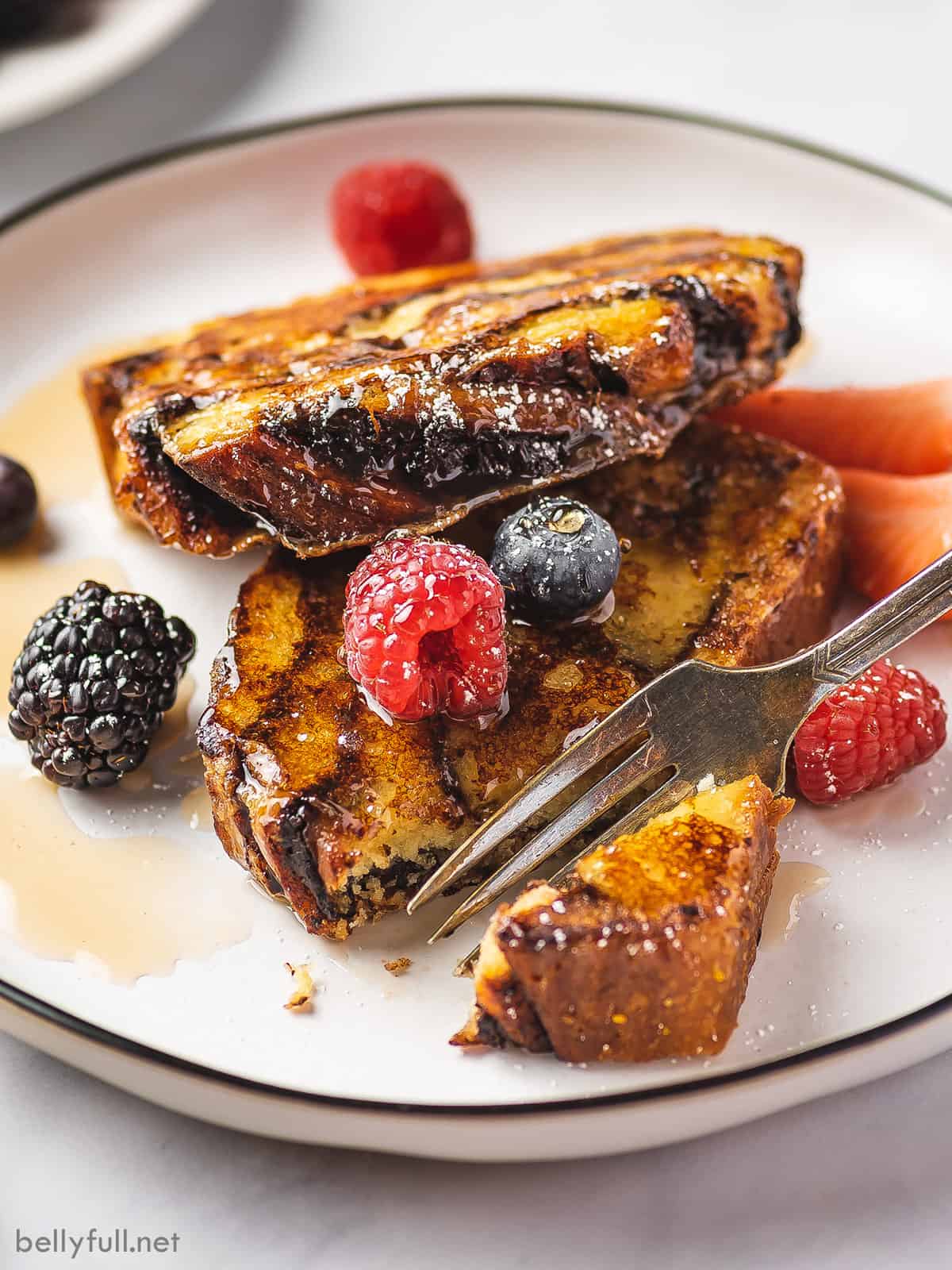 A fork cutting a piece of challah French toast