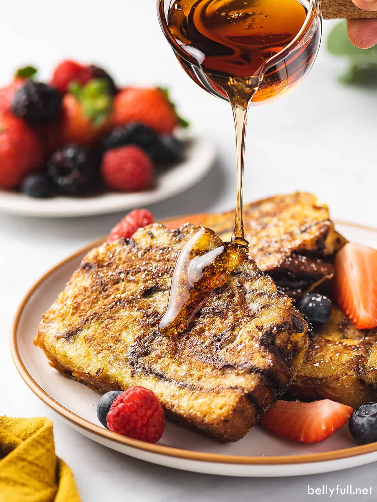 Syrup being poured over slices of French toast