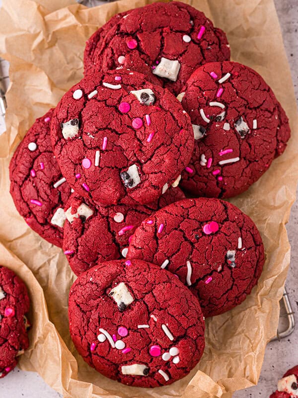 Overhead view of red velvet cookies on crinkled brown parchment paper