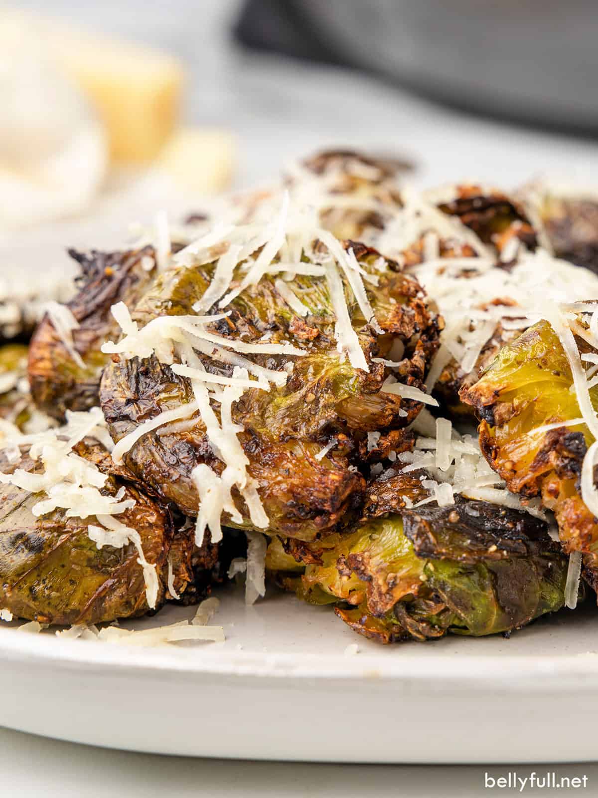 Angled view of air fryer brussels sprouts topped with parmesan