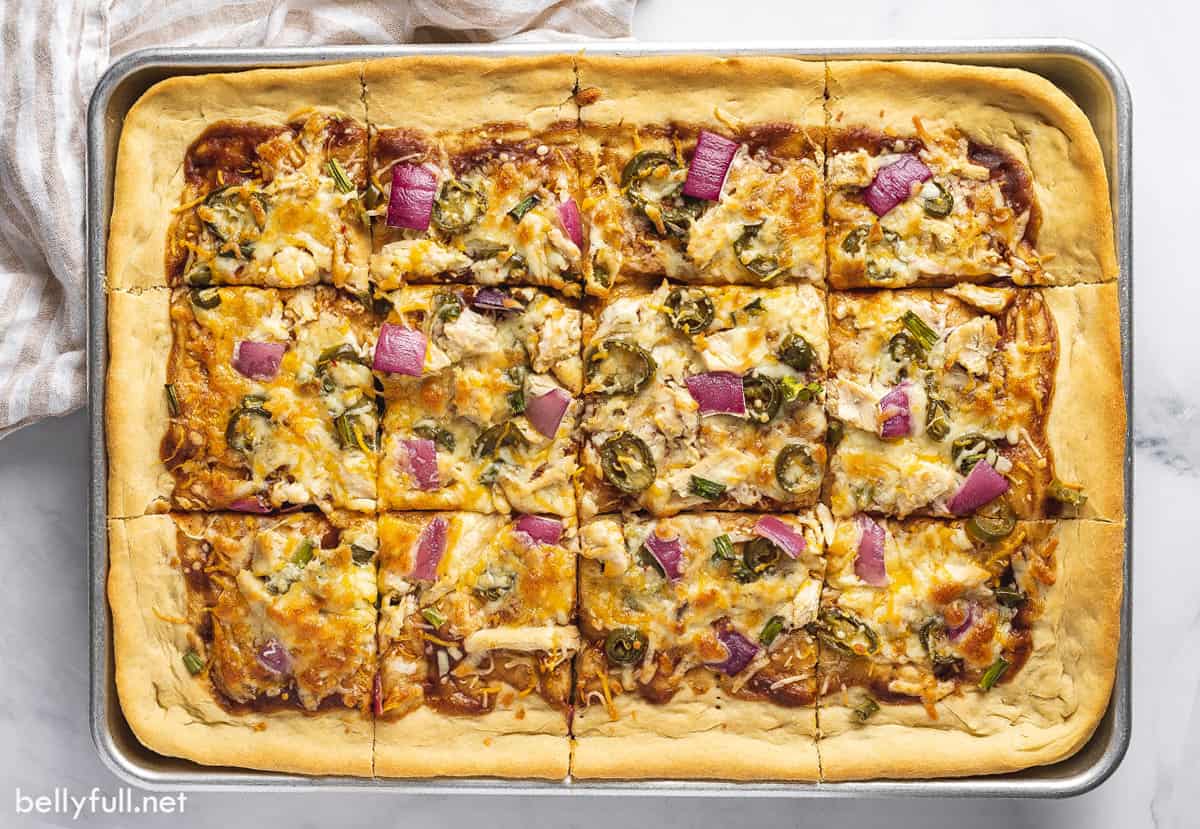 Overhead view of a BBQ chicken sheet pan pizza