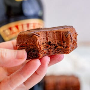 Bailey's brownie with bite taken being held in the air