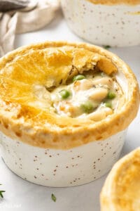 Overhead angled view of a homemade chicken pot pie in a ramekin