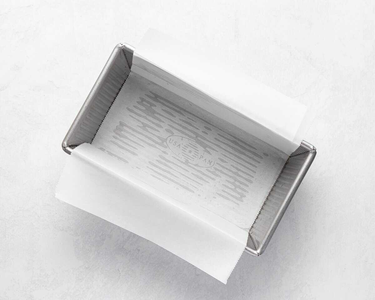 Greased loaf pan lined with parchment paper.