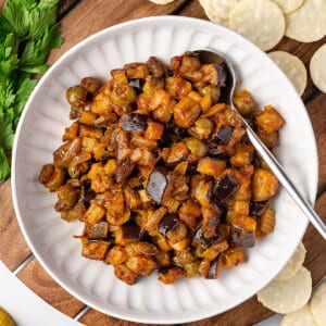 overhead caponata in white bowl with spoon