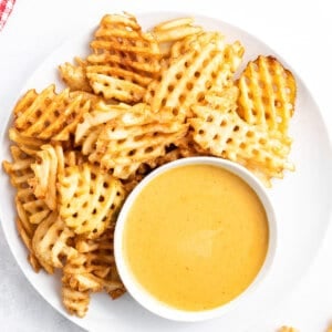 Overhead view of chick-fil-a sauce on a plate with waffle fries