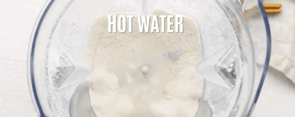 Blending rice with hot water in a blender.