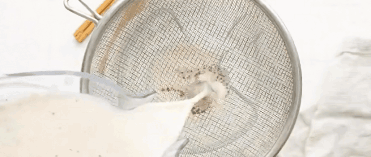 Straining the rice mixture over a fine mesh sieve.