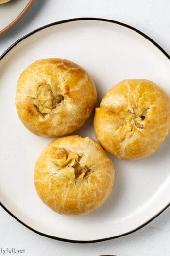 overhead 3 round baked potato filled pastries on white plate