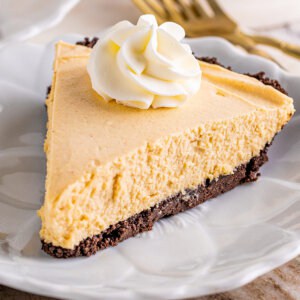 A slice of peanut butter pie topped with whipped cream