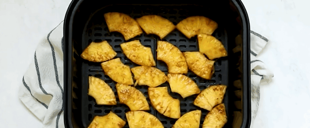 Pineapple slices in an air fryer. 