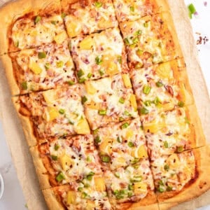 sheet pan Hawaiian pizza cut into squares