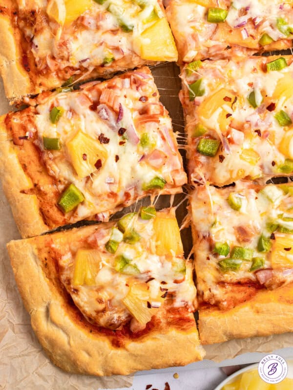 close up Hawaiian Pizza cut into squares