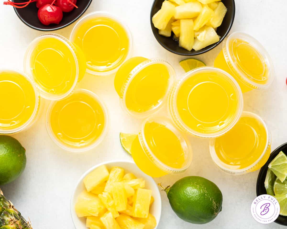 overhead pile of pineapple jello shots with lids