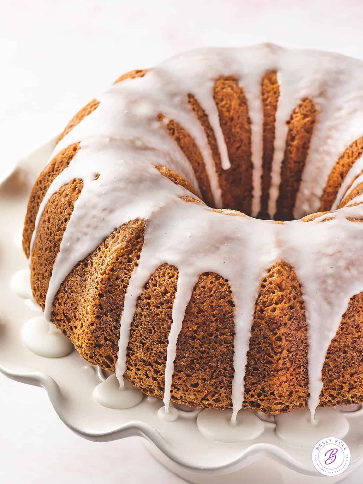 iced bundt cake on white cake stand