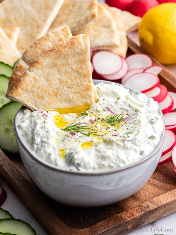 bowl of Tzatziki Sauce with pita triangles dipped
