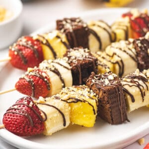 banana split dessert kabobs on white serving platter
