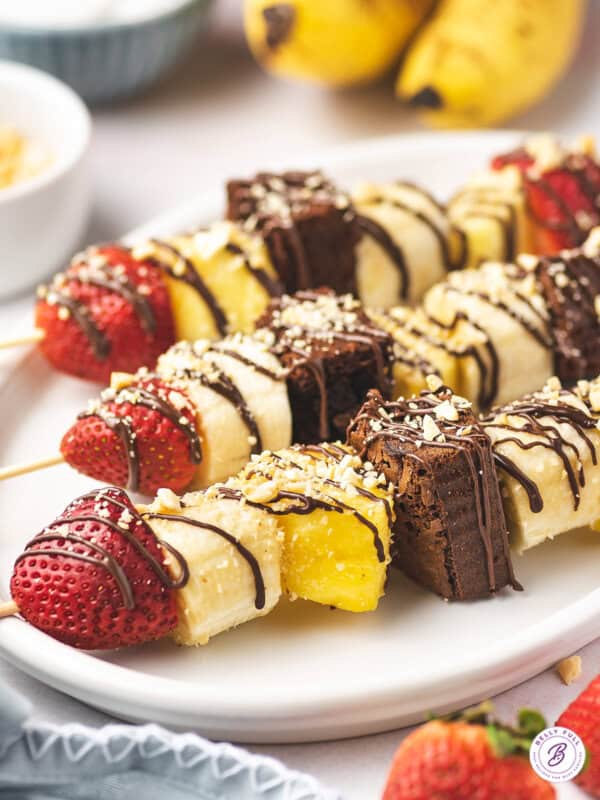 banana split dessert kabobs on white serving platter