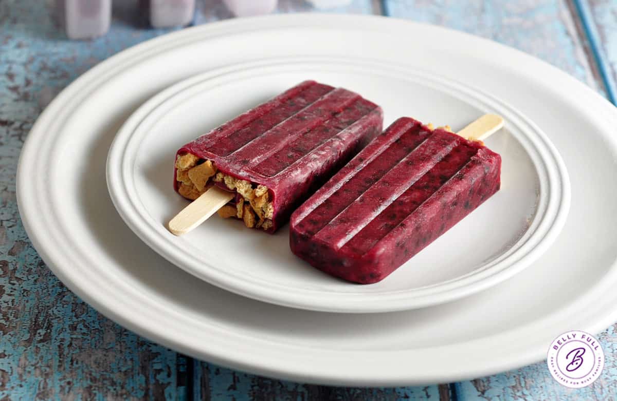 blackberry popsicles on white plate