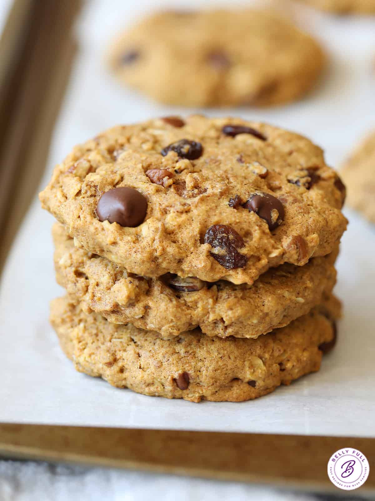 Stack of 3 large cookies on parchment paper