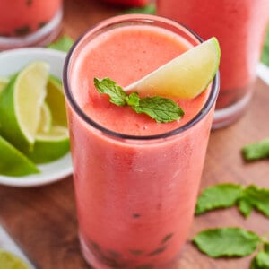 Close up frozen strawberry mojito with mint and lemon garnish
